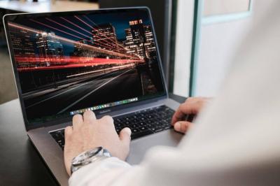 Laptop with a picture of fast city lights on the screen